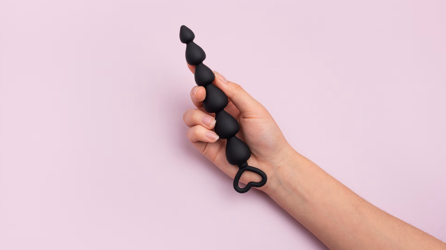 Black butt plug with pink background