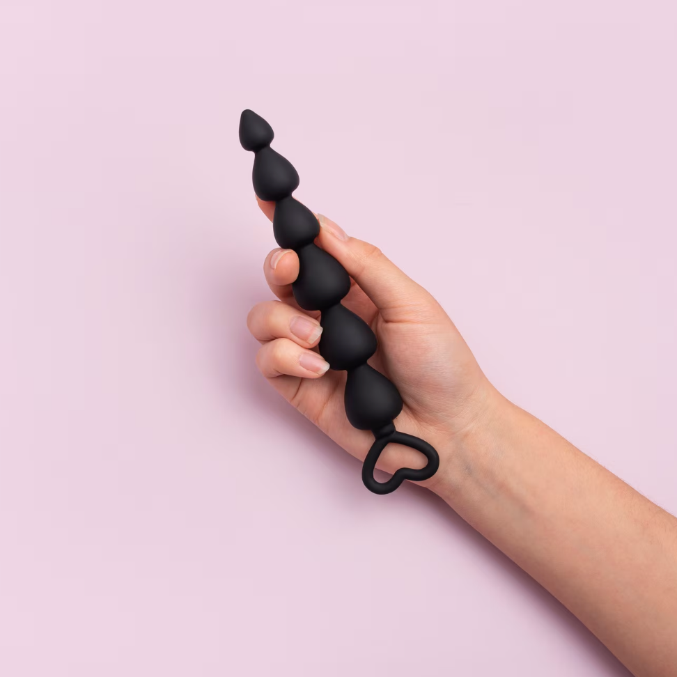 Black butt plug with pink background