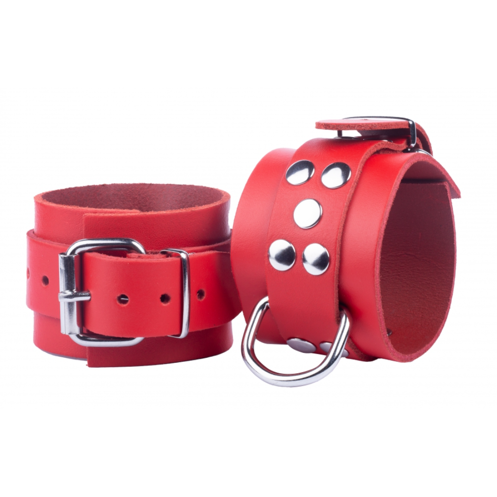 Black leather handcuffs with metal buckle and O-ring, designed for BDSM play, from Luvland's Fuck & Fist collection.