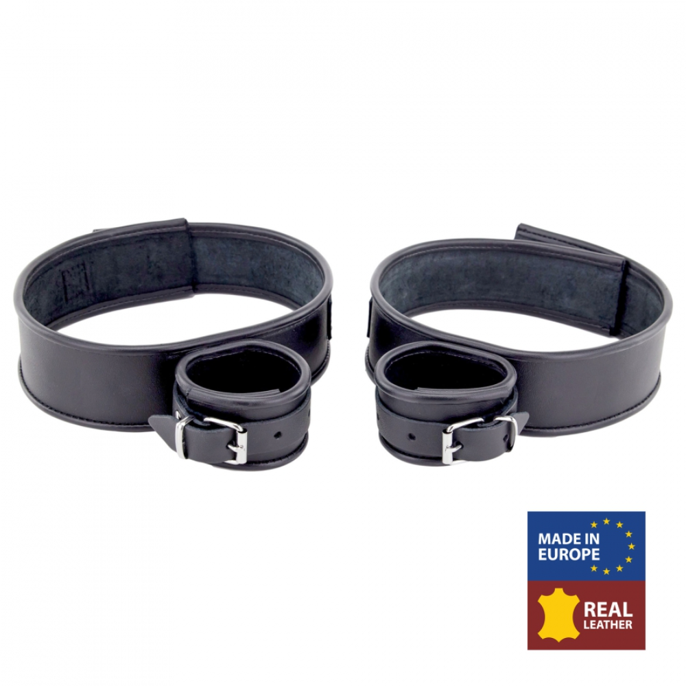 Black leather thigh and hand restraints from Fuck & Fist by Luvland, featuring adjustable straps and secure fastening.