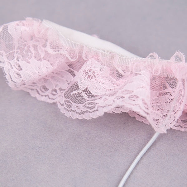 Luvland lace G-string with pearl embellishments, featuring delicate lace fabric and small pearl accents, on a neutral background.