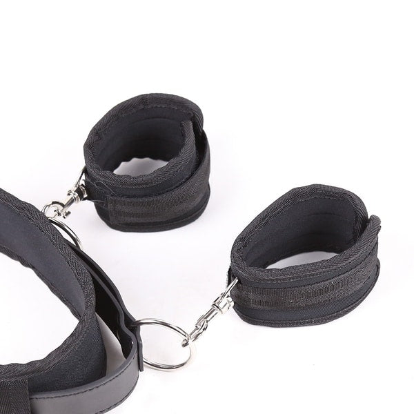 Black thigh and handcuffs restraint set by Ideal Leather, featuring sturdy leather straps and metal buckles for bondage play.