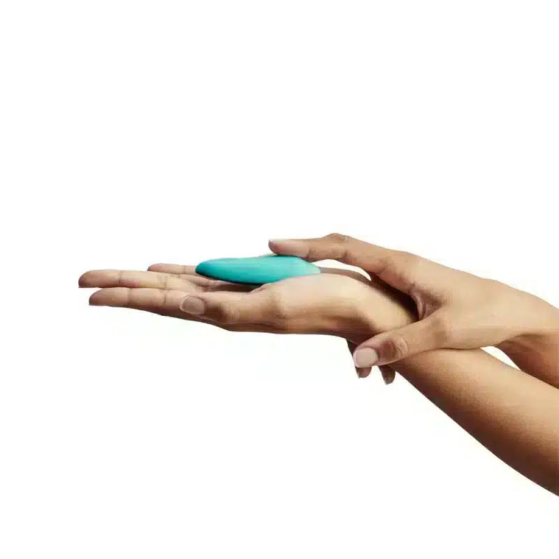 Luvland We Vibe Moxie and clitoral stimulator in aqua, featuring compact design and textured surface for targeted pleasure.
