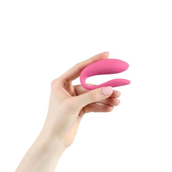 Pink We Vibe Sync Lite couples vibrator by Luvland, shown with smooth silicone surface and adjustable remote control in the image.