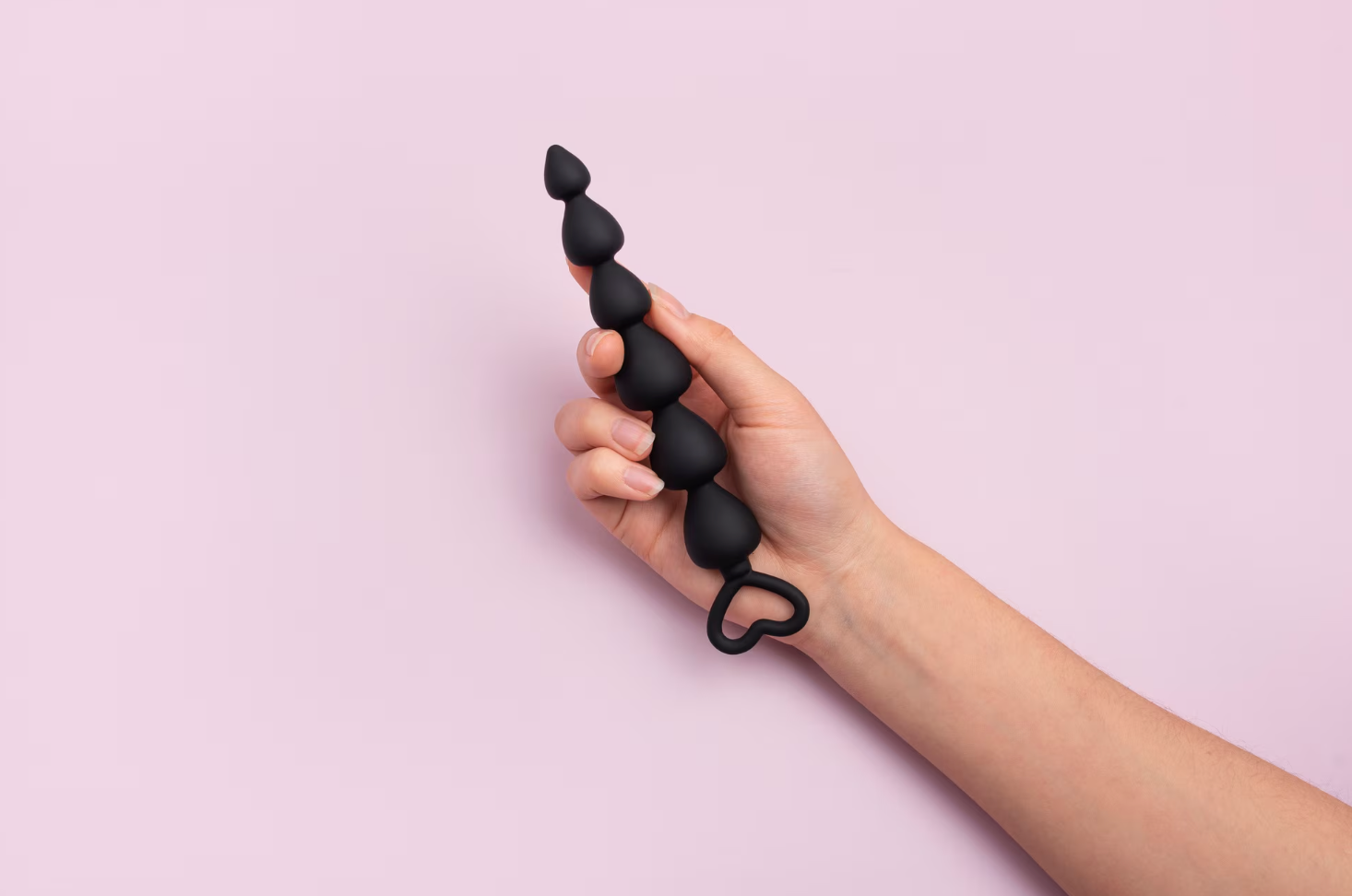 Black butt plug with pink background