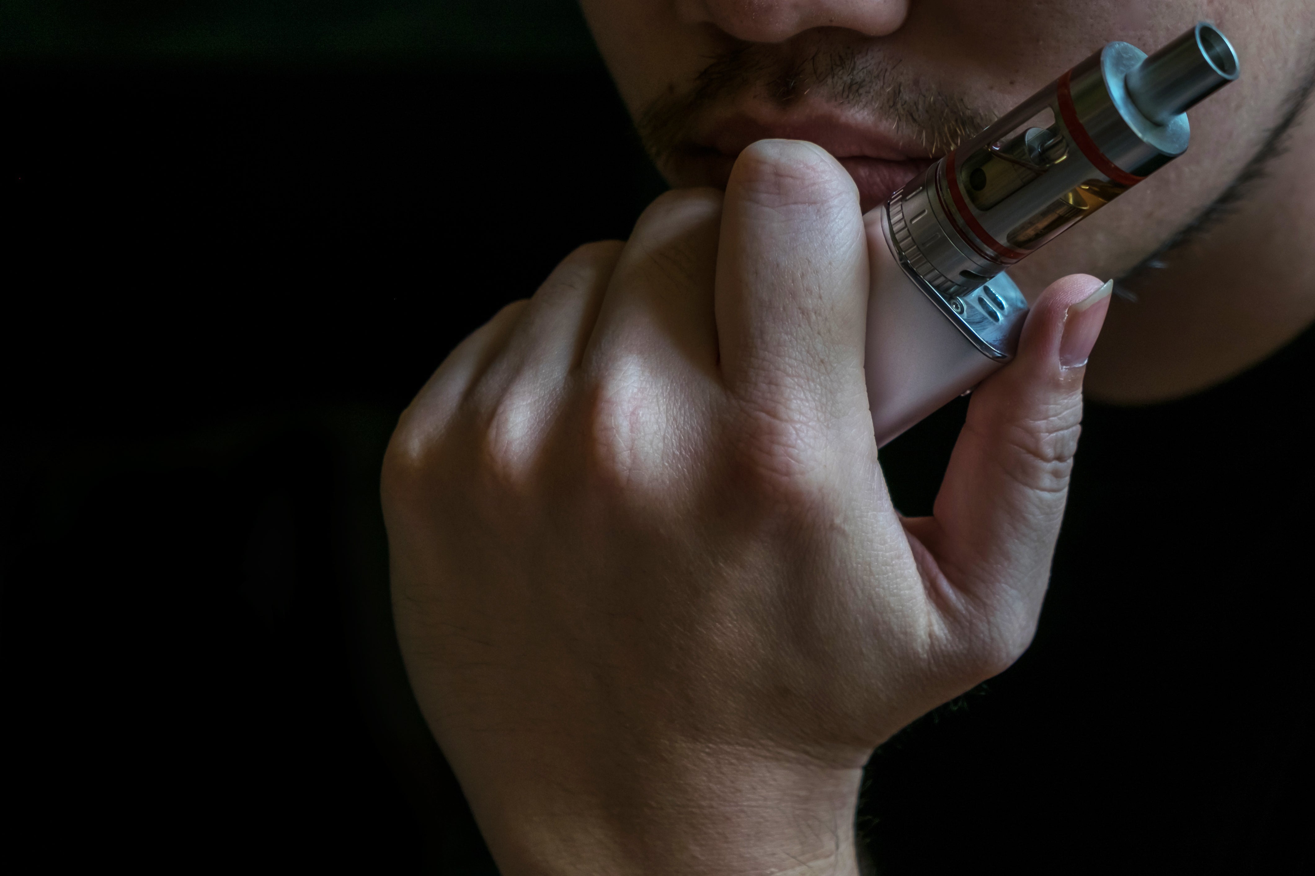 A man holding a vape to his face