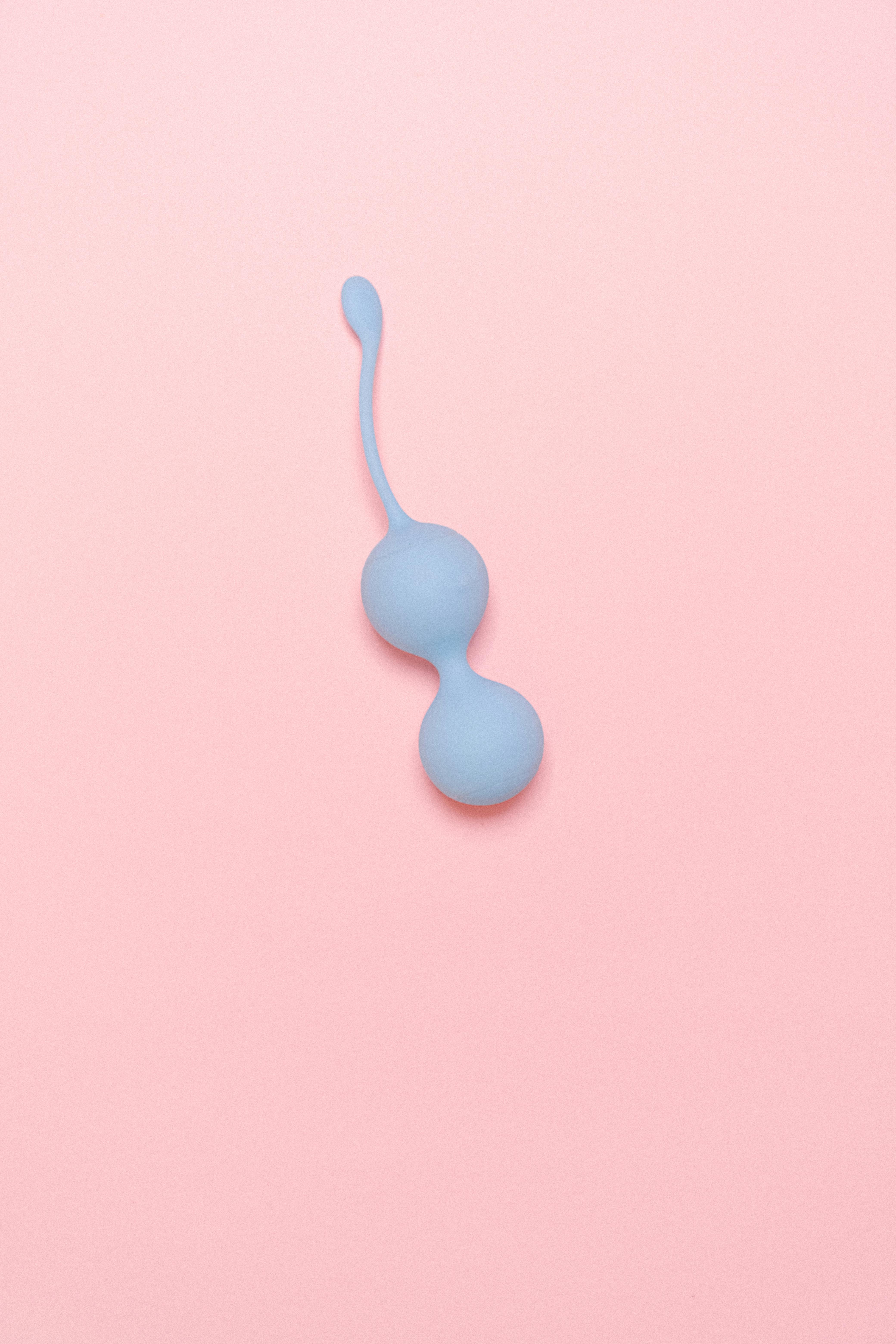 Blue Ben Wa Balls for women on a pink background