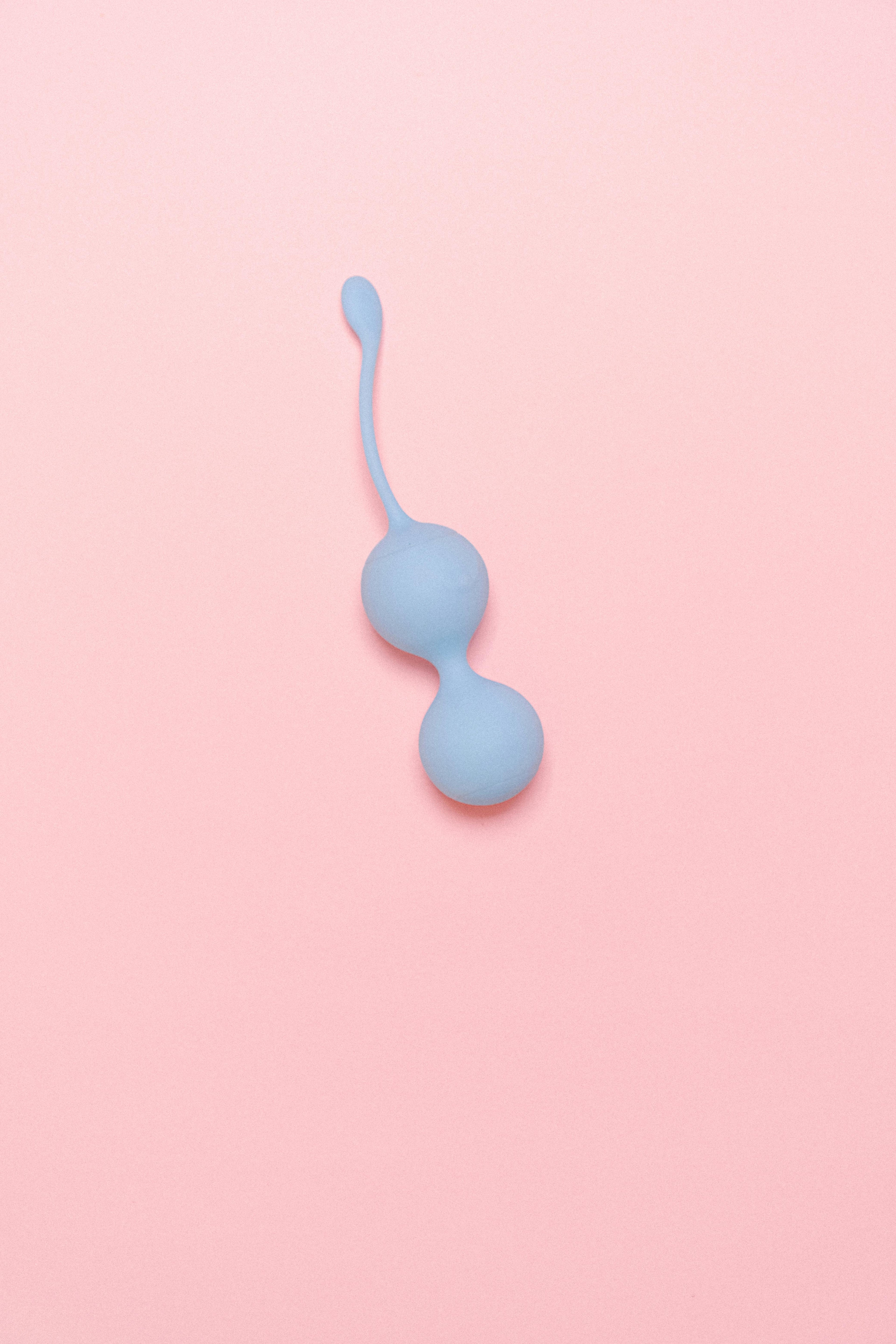 Blue Ben Wa Balls for women on a pink background
