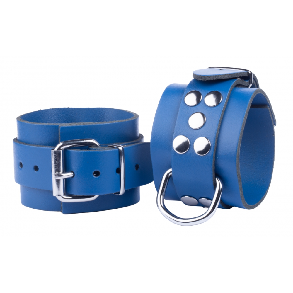 Pair of black leather handcuffs from Luvland's Fuck & Fist collection, featuring sturdy metal clasps and adjustable straps.
