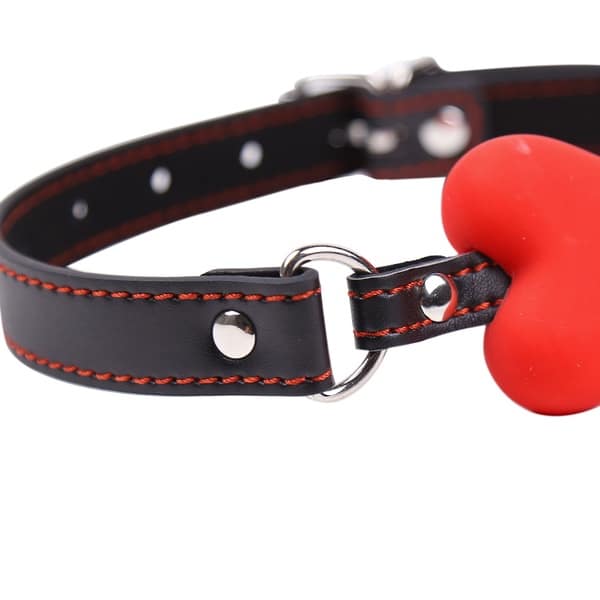 Red bone gag with black leather strap from Ideal Leather, featuring adjustable buckles and secure fastening for BDSM use.