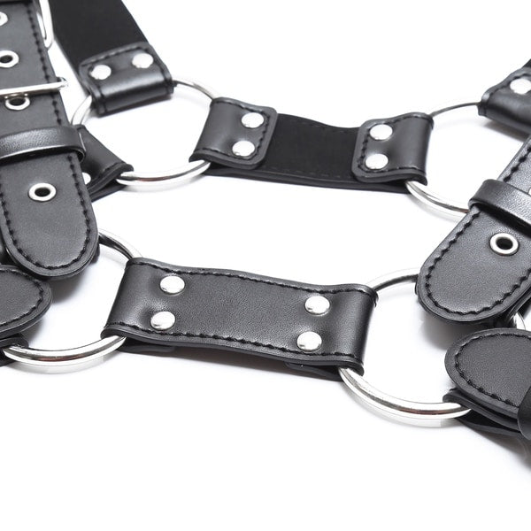 Black 4-strap body harness by Ideal Leather featuring adjustable straps and metal hardware for a stylish, edgy look.