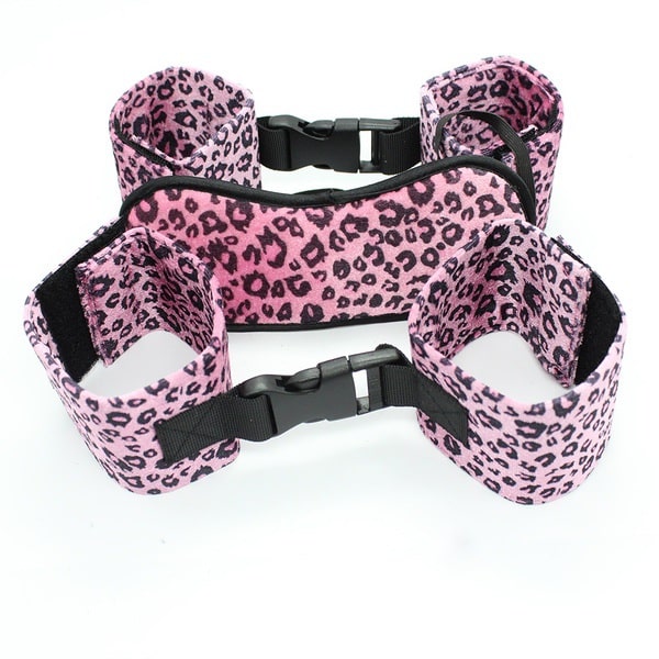 Pink leopard print blindfold with matching leather wrist and ankle cuffs by Ideal Leather, designed for sensory play and restraint.