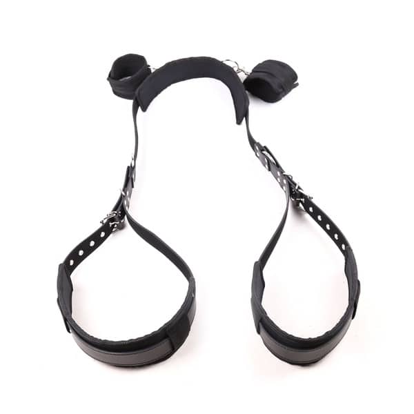 Black thigh and handcuffs restraint set by Ideal Leather, featuring adjustable straps and metal hardware for bondage play.