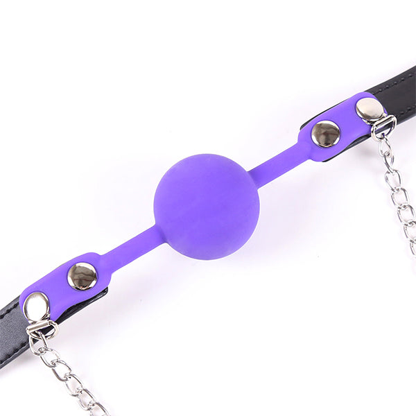 Purple gag with chained nipple clamps from Ideal Leather, featuring a leather strap and metal chain for BDSM restraint and play.