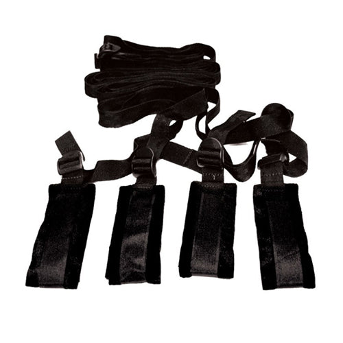 Sportsheets Sex & Mischief Bed Bondage Restraint Kit with adjustable cuffs and straps on a bed for intimate restraint play.