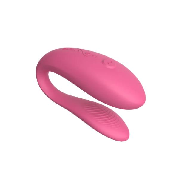 Pink We Vibe Sync Lite by Luvland, a compact couples vibrator with adjustable settings, shown in a close-up view.